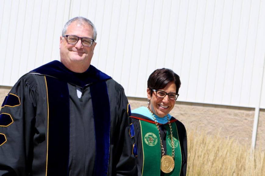 president schumacher and peter holbrook in robes at convocation